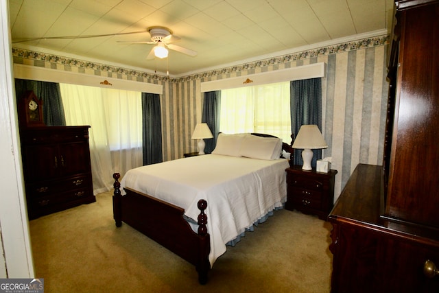 bedroom featuring light carpet, ceiling fan, and crown molding