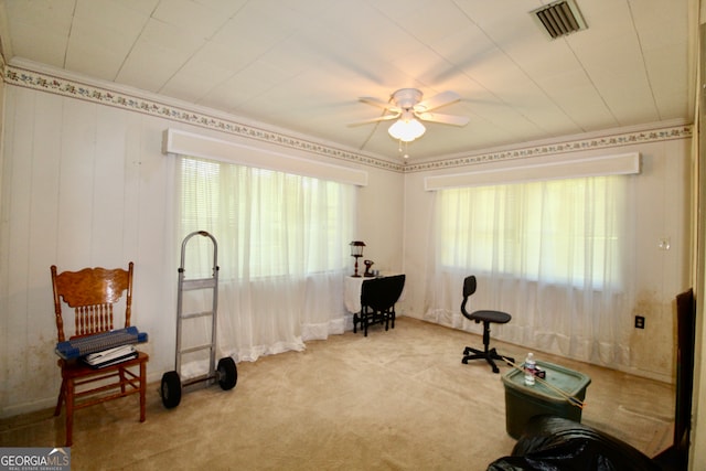 exercise area with ceiling fan and light carpet