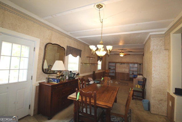 dining space featuring a healthy amount of sunlight and ceiling fan with notable chandelier