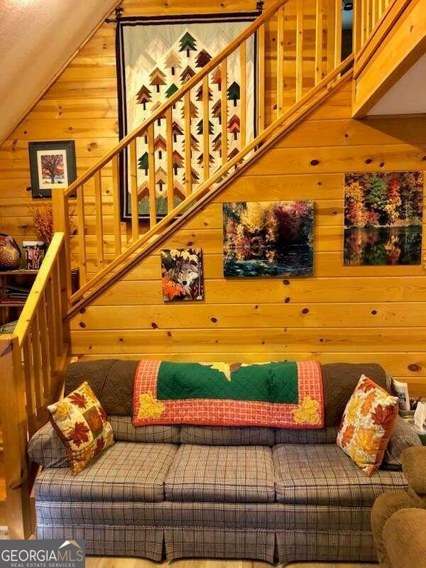 interior space featuring wood walls and lofted ceiling