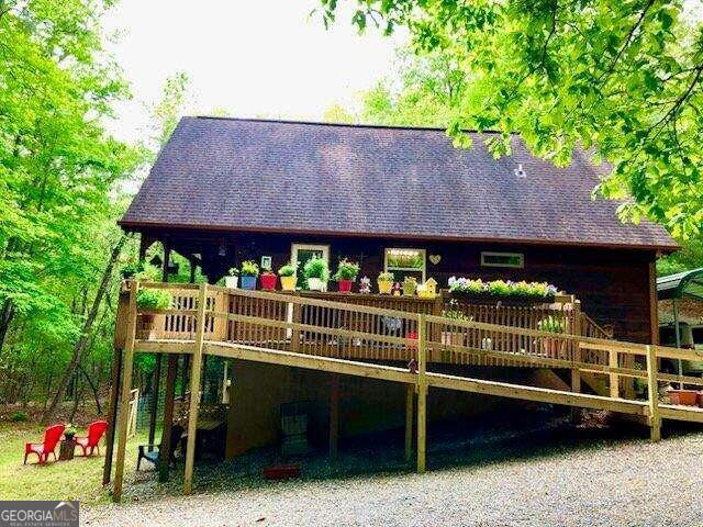 rear view of property featuring a wooden deck