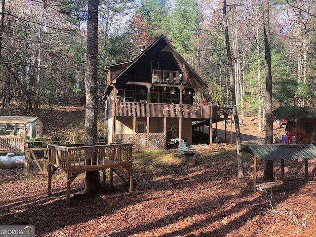 back of house featuring a deck