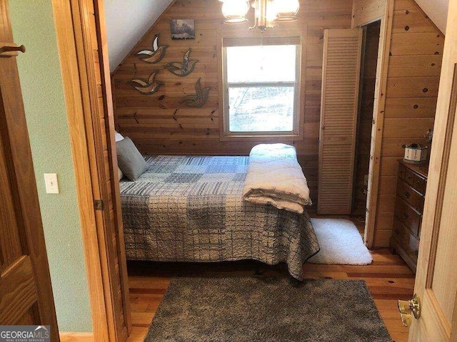 bedroom featuring vaulted ceiling and hardwood / wood-style flooring