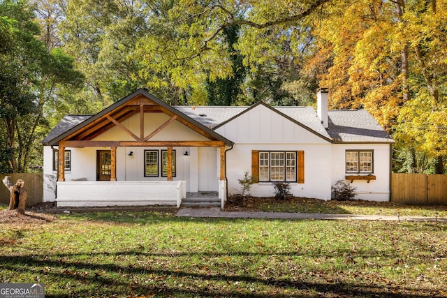 view of front of property with a front yard and a porch