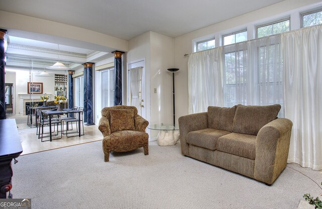 carpeted living room featuring a tiled fireplace