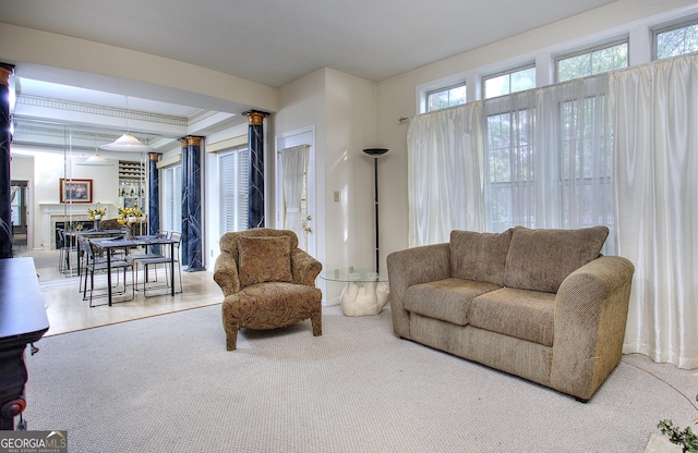 living room with ornamental molding, a fireplace, and carpet floors