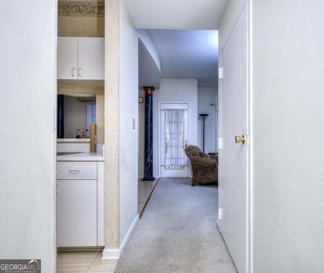 sitting room with carpet flooring, ceiling fan, and a textured ceiling