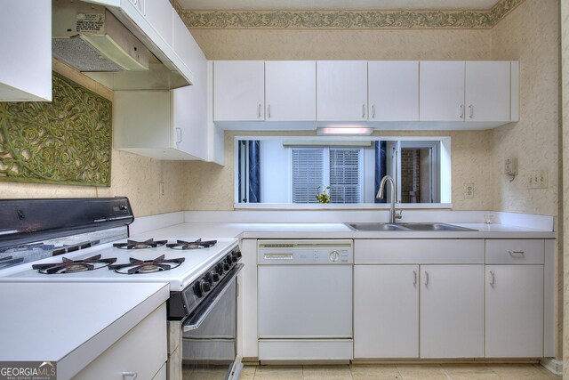 kitchen featuring white cabinets, light tile patterned floors, white appliances, and sink