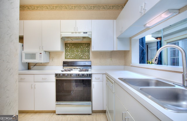 kitchen with sink, light tile patterned flooring, white appliances, decorative backsplash, and white cabinets