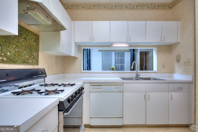 kitchen with white cabinets, light tile patterned flooring, white appliances, and sink