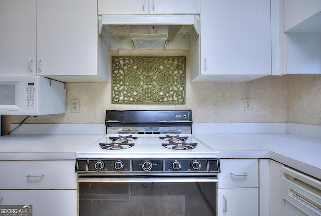 kitchen with white microwave, under cabinet range hood, white cabinetry, range with gas stovetop, and light countertops