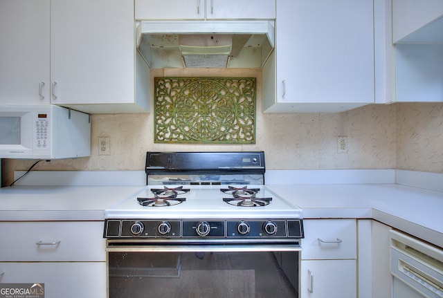 kitchen featuring white cabinets, decorative backsplash, and black range