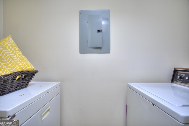 laundry area with laundry area, washer and clothes dryer, and electric panel