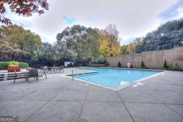 view of swimming pool featuring a patio