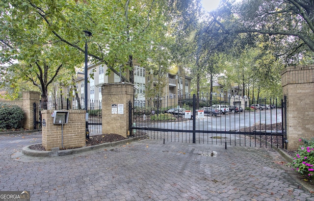 view of gate with a residential view and fence