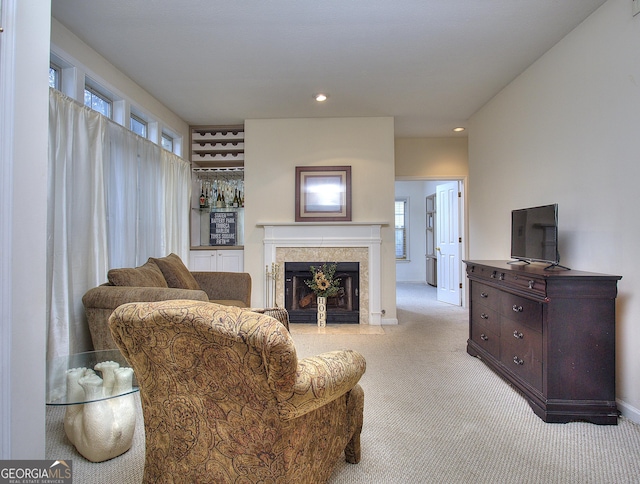 living area with light carpet, recessed lighting, baseboards, and a tile fireplace