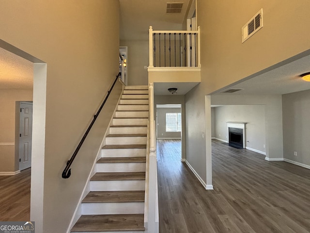 stairway featuring hardwood / wood-style floors and a textured ceiling