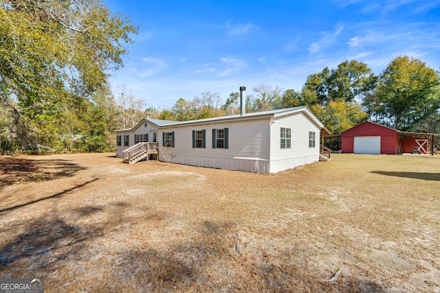 exterior space with a garage and an outdoor structure