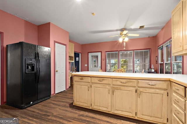 kitchen featuring black fridge, kitchen peninsula, dark wood-type flooring, and light brown cabinetry