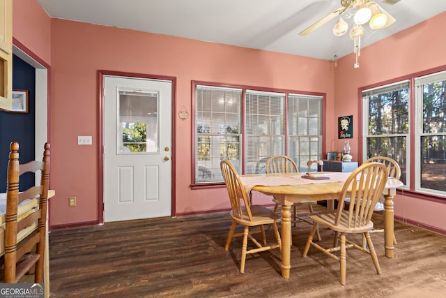 dining space with ceiling fan and dark wood-type flooring