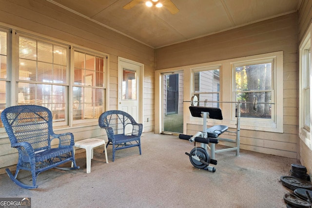 interior space with ceiling fan