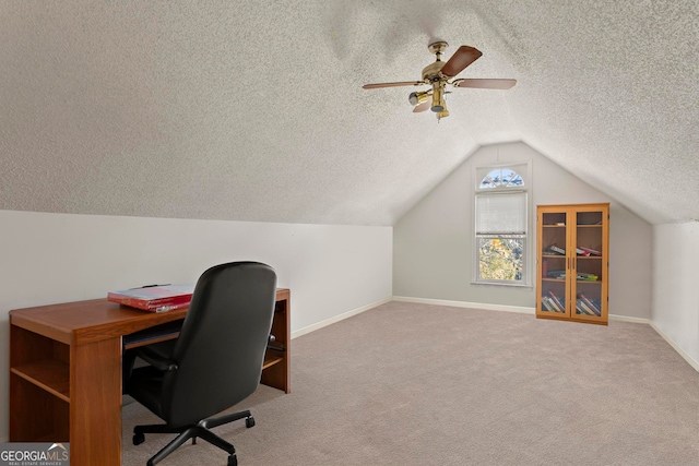 carpeted office space with a textured ceiling, ceiling fan, and vaulted ceiling