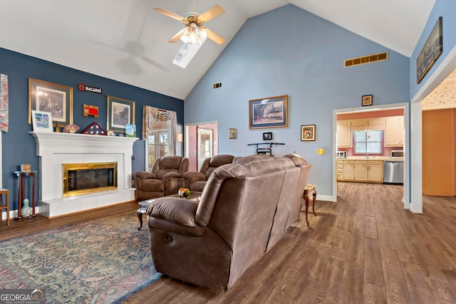 living room with hardwood / wood-style floors, high vaulted ceiling, a wealth of natural light, and ceiling fan