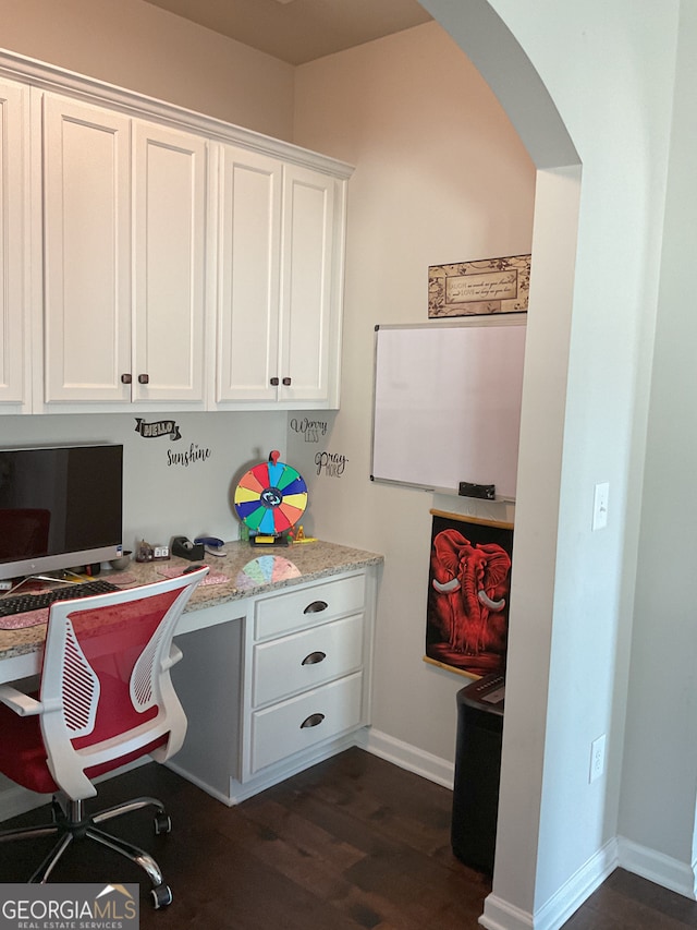 office area with built in desk and dark wood-type flooring