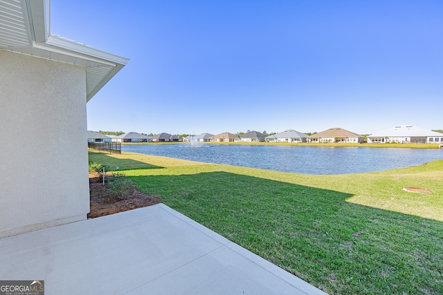 view of yard featuring a patio area and a water view