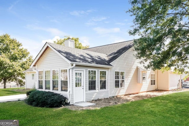 rear view of house with a lawn