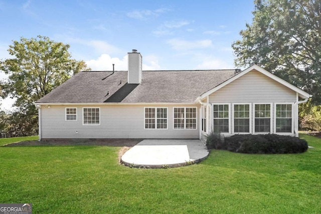 rear view of property with a yard and a patio