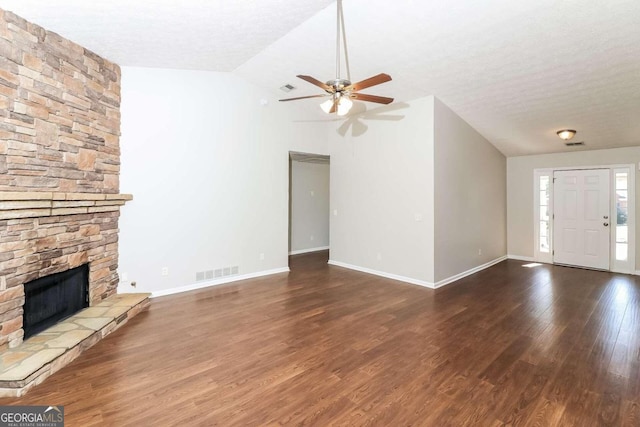 unfurnished living room with a textured ceiling, ceiling fan, dark hardwood / wood-style flooring, and lofted ceiling