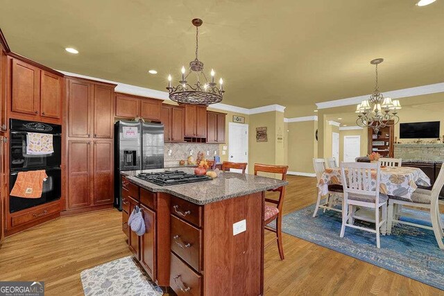 kitchen featuring a chandelier, light hardwood / wood-style flooring, and stainless steel appliances