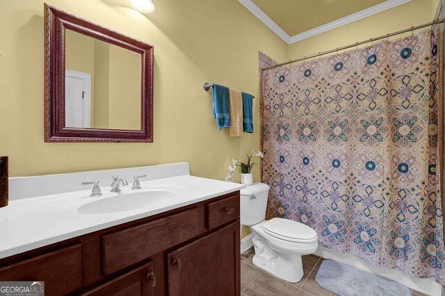 bathroom with curtained shower, tile patterned floors, toilet, vanity, and ornamental molding