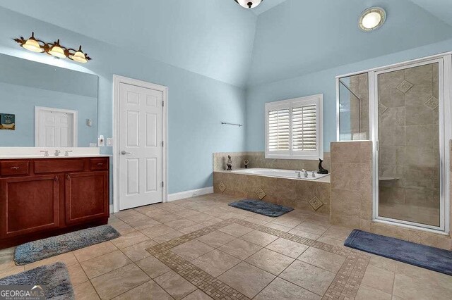 bathroom with tile patterned floors, vanity, high vaulted ceiling, and independent shower and bath