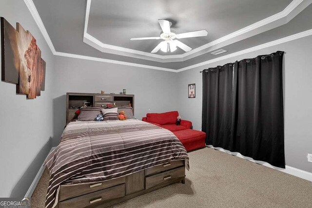 carpeted bedroom featuring ceiling fan, a raised ceiling, and ornamental molding