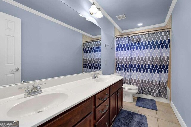 bathroom featuring a shower with shower curtain, ornamental molding, vanity, tile patterned flooring, and toilet