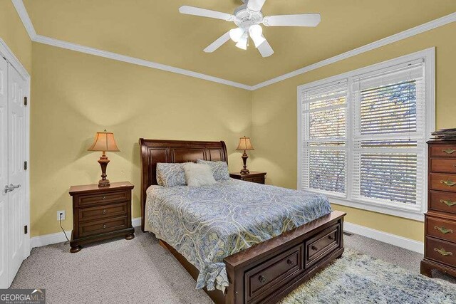 bedroom featuring light carpet, ceiling fan, and ornamental molding