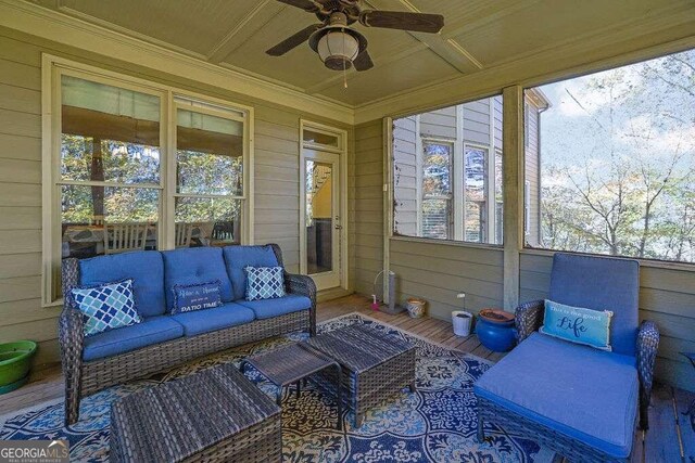 sunroom / solarium with ceiling fan and coffered ceiling