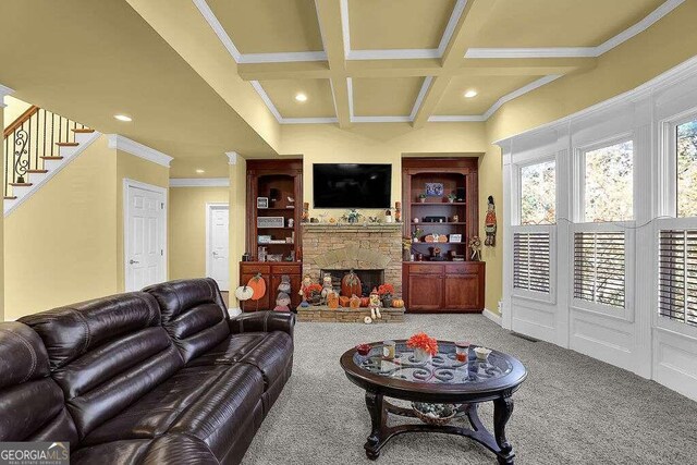 living room featuring carpet flooring, ornamental molding, coffered ceiling, beam ceiling, and a fireplace