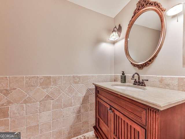 bathroom with vanity and tile walls