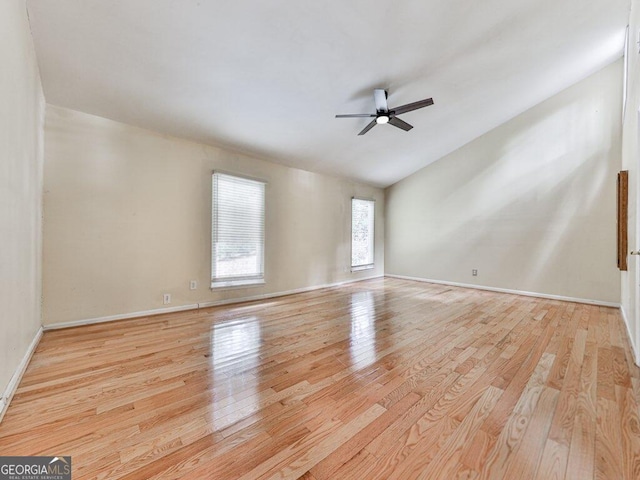 empty room featuring ceiling fan, light hardwood / wood-style floors, and lofted ceiling