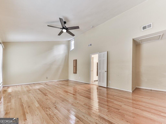 spare room with light hardwood / wood-style floors, high vaulted ceiling, and ceiling fan