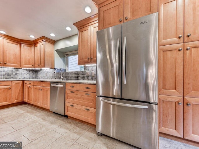 kitchen featuring decorative backsplash, sink, and appliances with stainless steel finishes