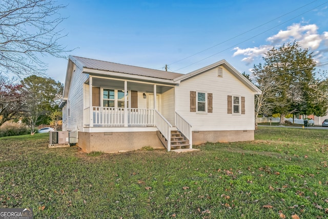 view of front of property with a porch, a front lawn, and cooling unit