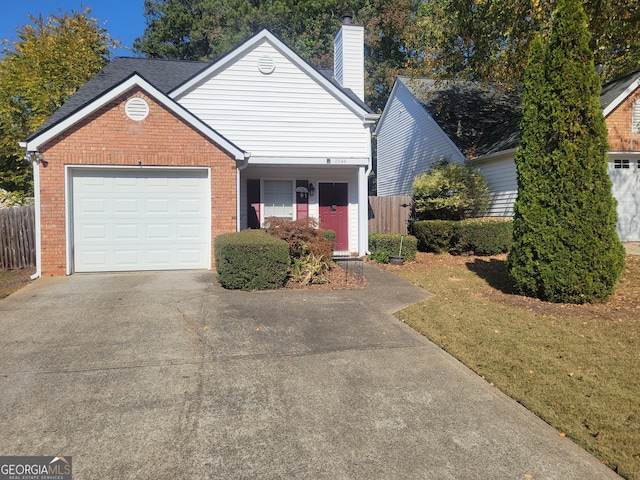 view of front facade with a garage and a front lawn