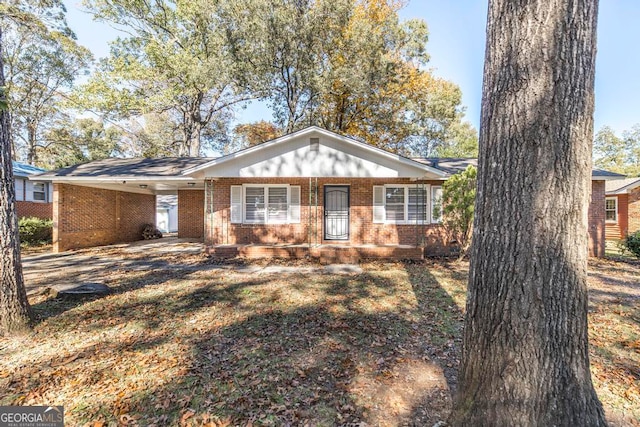 single story home featuring a carport