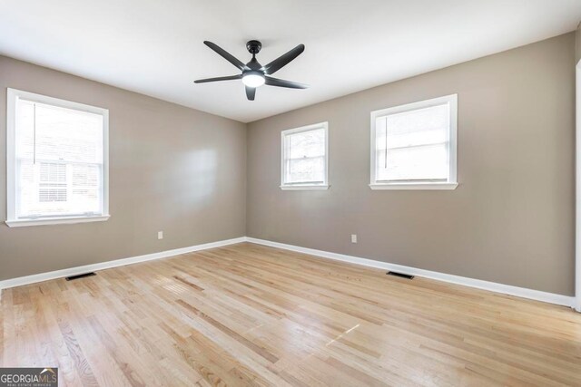 unfurnished bedroom featuring light wood-type flooring, connected bathroom, and ceiling fan