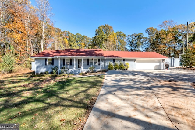 ranch-style house with a porch, a garage, and a front lawn