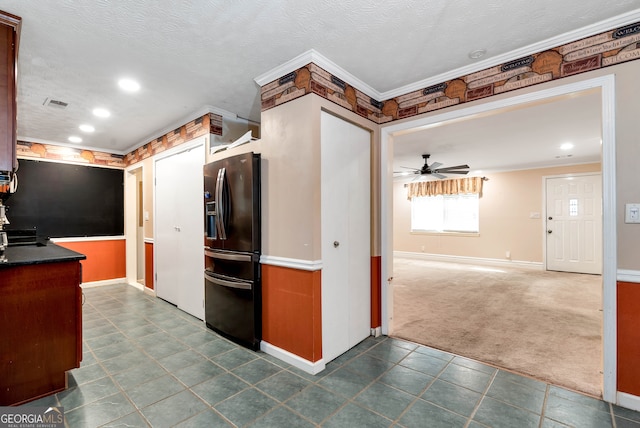 kitchen with ceiling fan, dark colored carpet, a textured ceiling, black fridge with ice dispenser, and ornamental molding